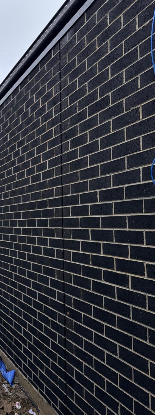 The same blank brick elevation after cleaning, with an even finish across the full height