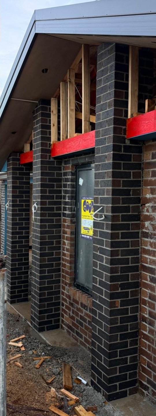 The same brick entry piers after cleaning, with clean brickwork and sharp arrises